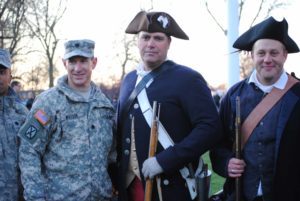 A modern soldier and two Revolutionary War reenactors symbolizing centuries of American service. Taken on the Lexington Battle Green on Patriots Day