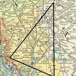 A detailed map of southeastern Massachusetts with towns such as Taunton, Bridgewater, Easton, and North Dighton labeled. A large black triangle is drawn over the map, with its three points marking the traditional borders of the Bridgewater Triangle. The shaded regions, roads, and town names remain visible beneath the triangle, highlighting the area’s geography and the towns enclosed within the Triangle’s boundaries.