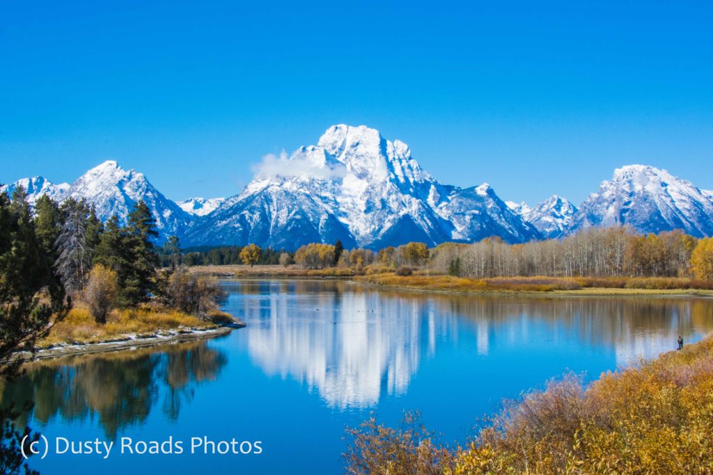 Crisp autumn morning at Mount Moran in Grand Teton National Park, the snowy peak mirrored perfectly in the calm water below.
