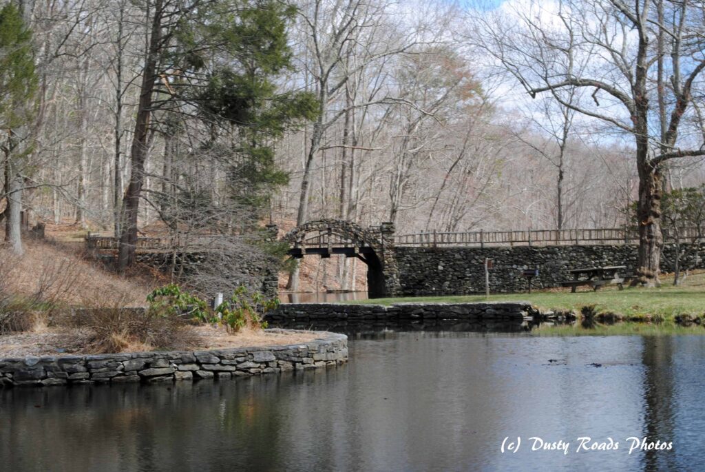stone bridge over a quiet pond at Gillette Castle State Park in early spring”