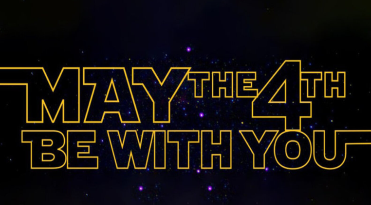 Bold yellow “May the 4th Be With You” text in a Star Wars–style font against a starry space background.