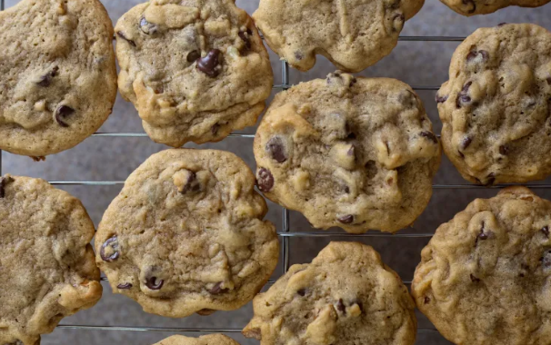 Freshly baked chocolate chip cookies cooling on a wire rack