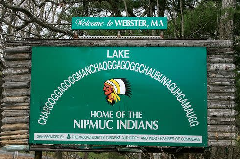 Welcome sign in Webster, Massachusetts featuring the full name of Webster Lake (Chargoggagoggmanchauggagoggchaubunagungamaugg) and referencing the Nipmuc Indian heritage.