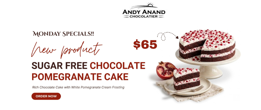 An advertisement for Andy Anand’s Monday Special featuring a sugar‑free chocolate pomegranate cake. The image shows a whole chocolate cake on a stand with white pomegranate cream frosting and a slice cut out. A plated slice sits beside it, along with a whole pomegranate. The text highlights the cake as a new product priced at $65, with a red “Order Now” button below.