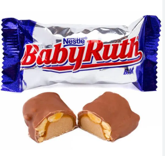 “A Nestlé Baby Ruth candy bar in a silver and blue wrapper, with a cut piece in front showing layers of caramel, peanuts, and nougat covered in milk chocolate.”