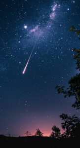 meteor or shooting star streaks across the sku with milkly way in the background