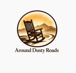 A circular logo featuring an angled rocking chair on a winding road leading toward distant mountains under a warm sunrise glow, with the words “Around Dusty Roads” below.