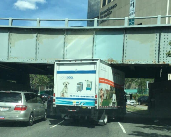 Another truck stuck under a low Boston bridge, illustrating a classic Storrowing-style move‑in mishap.